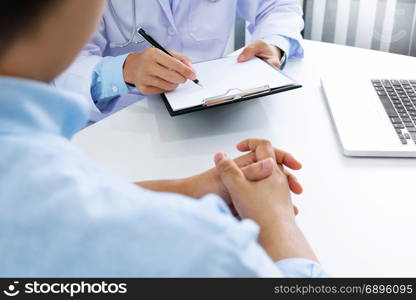 close up of patient and doctor taking notes in a hospital or clinic