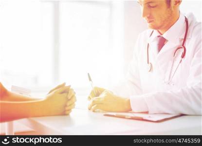 close up of patient and doctor taking notes. patient and doctor taking notes