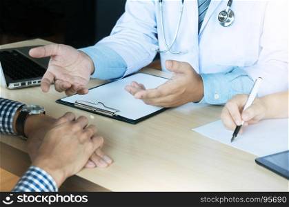 close up of patient and doctor writing something on clipboard Ward round, patient visit check, Medicine and health care concept. Physician ready to examine patient.
