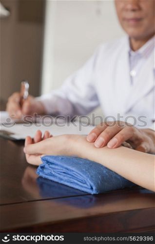 Close Up of Patient&rsquo;s Hand While Doctor Takes Pulse