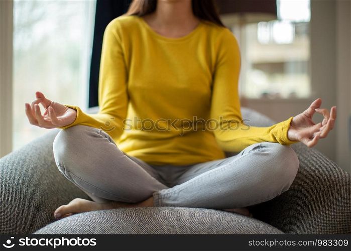 Close Up Of Peaceful Woman Meditating Sitting In Chair At Home
