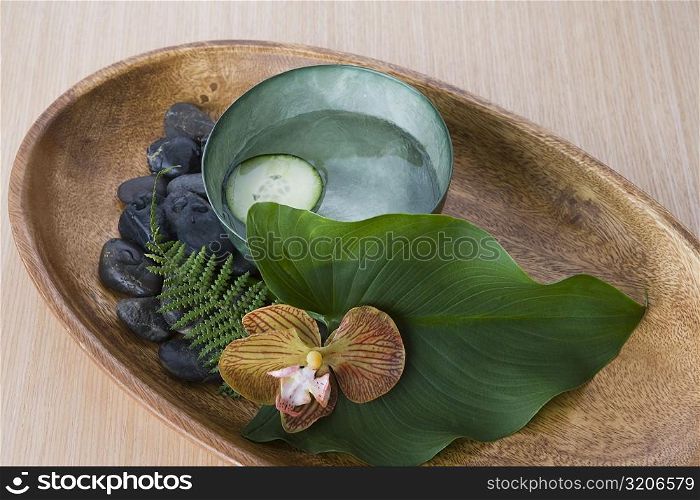 Close-up of pebbles with leaf and herbs in a tray