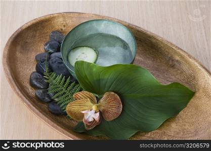 Close-up of pebbles with leaf and herbs in a tray