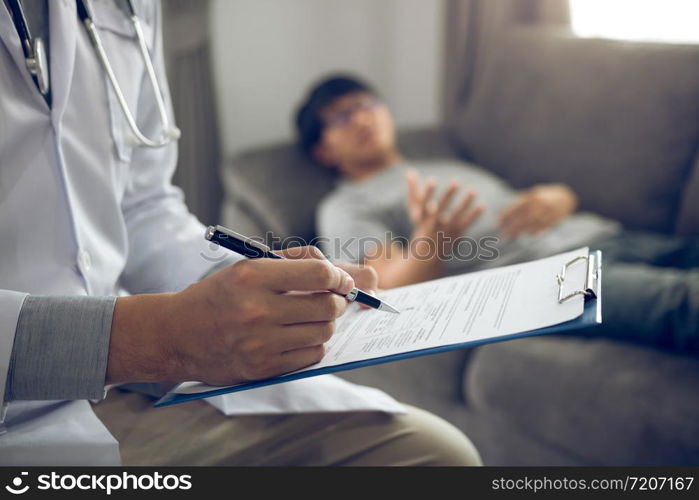 Close up of pen doctor writing with came to visit the patient at home while he was suffering from stomach ulcers and noted the treatment results.