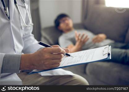 Close up of pen doctor writing with came to visit the patient at home while he was suffering from stomach ulcers and noted the treatment results.