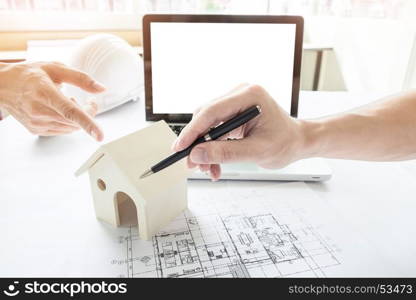 Close-up Of Person's engineer Hand Drawing Plan On Blue Print with architect equipment.