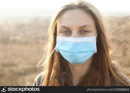 close up of Photo of a woman wearing protective mask against infectious diseases, coronavirus, covid-19 and flu outdoors. copy space. Coronavirus outbreak in Europe. Flu epidemic spread prevention.. close up of Photo of a woman wearing protective mask against infectious diseases, coronavirus, covid-19 and flu outdoors. copy space. Coronavirus outbreak in Europe. Flu epidemic spread prevention
