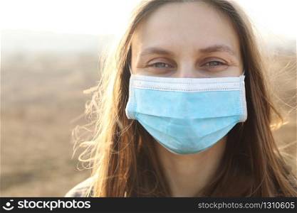 close up of Photo of a woman wearing protective mask against infectious diseases, coronavirus, covid-19 and flu outdoors. copy space. Coronavirus outbreak in Europe. Flu epidemic spread prevention.. close up of Photo of a woman wearing protective mask against infectious diseases, coronavirus, covid-19 and flu outdoors. copy space. Coronavirus outbreak in Europe. Flu epidemic spread prevention