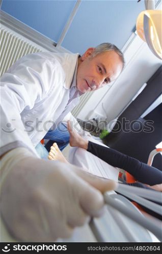 close-up of physical therapist diagnosing woman