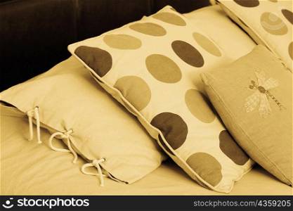 Close-up of pillows and cushions on the bed