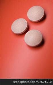 Close-up of pills on a red background