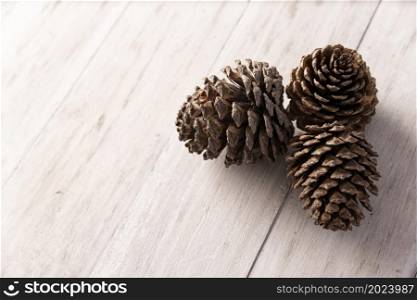 close up of pine cones on white wooden background. Copy space for your text