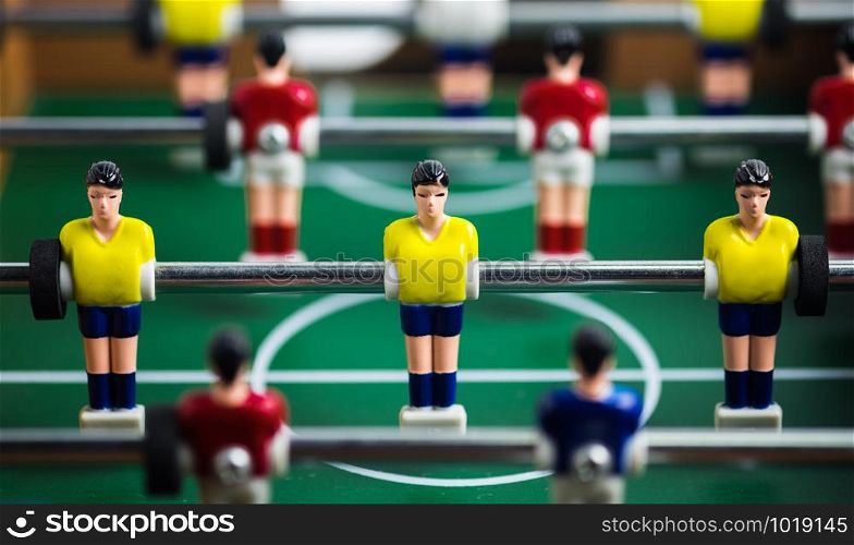 Close up of player on mini football game on table, The concept of fighting in business, vignette filter effect and selective focus.