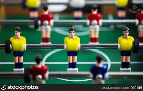 Close up of player on mini football game on table, The concept of fighting in business, vignette filter effect and selective focus.