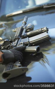 Close-up of police weapon on car bonnet