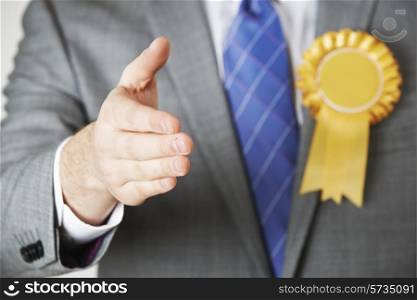 Close Up Of Politician Reaching Out To Shake Hands