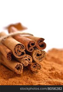 Close-up of powdered cinnamon with sticks isolated background