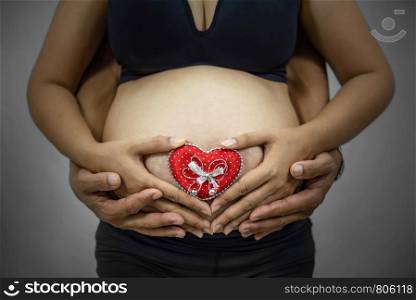 Close up of pregnant asian woman in black underwear. pregnant asian woman