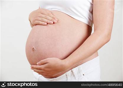 Close Up Of Pregnant Woman Holding Belly