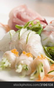 Close-up of prepared fishes topped with caviar in a plate