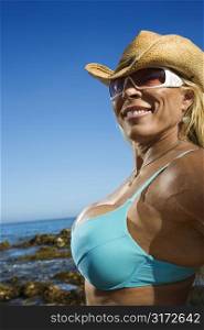 Close up of pretty Caucasian mid adult woman bodybuilder in bikini on Maui beach.