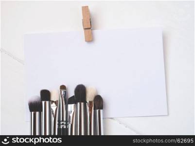 Close-up of professional dirty makeup brushes on paper card (color toned image, shallow DOF).