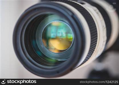Close up of professional photo camera on a tripod, lens