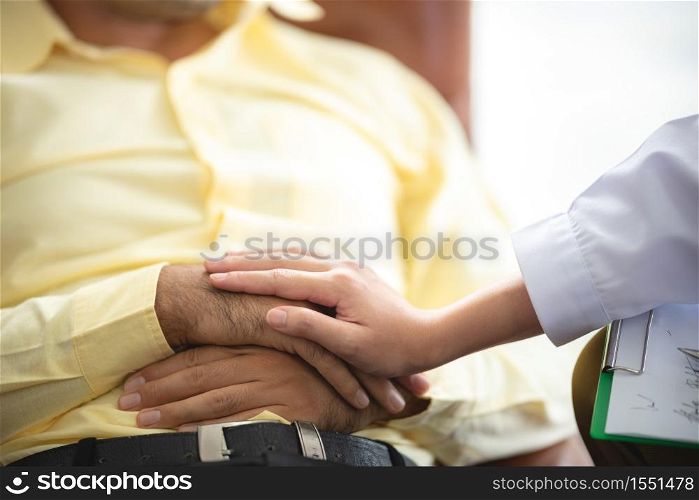 Close-up of psychologist comforting his depressed patient, mental health concept
