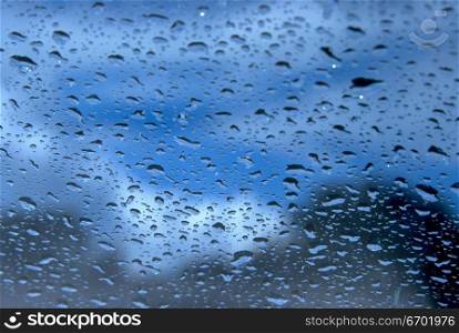 Close-up of raindrops through a glass pane
