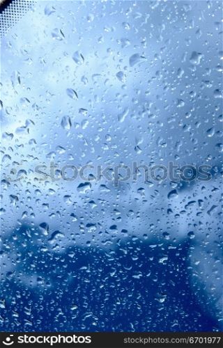 Close-up of raindrops through a glass pane