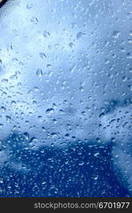 Close-up of raindrops through a glass pane