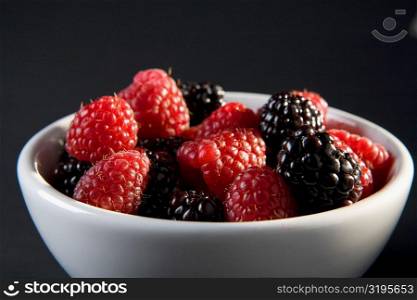 Close-up of raspberries and blackberries in a bowl