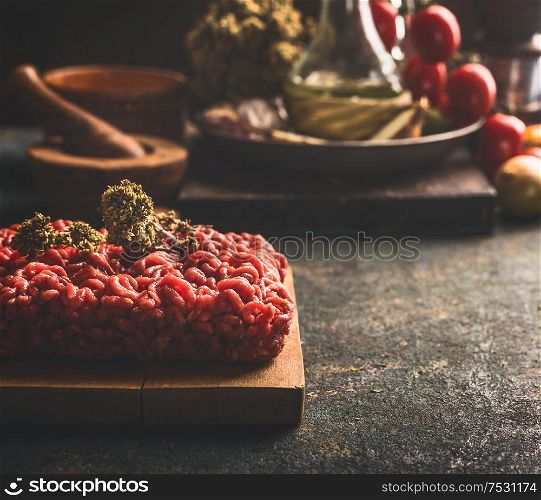 Close up of raw minced meat on dark rustic kitchen table. Copy space