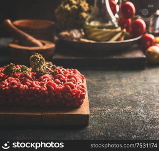 Close up of raw minced meat on dark rustic kitchen table. Copy space