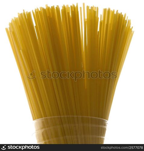 Close-up of raw spaghetti in a glass