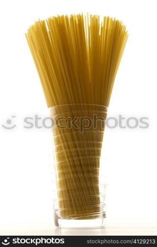 Close-up of raw spaghetti in a glass