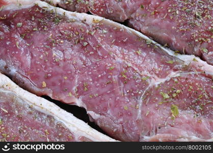Close-up of raw spiced red meat