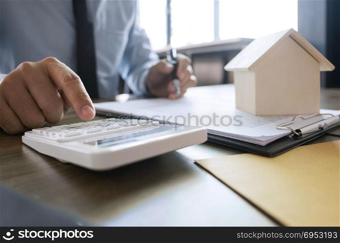 close up of real estate agent calculating sale report