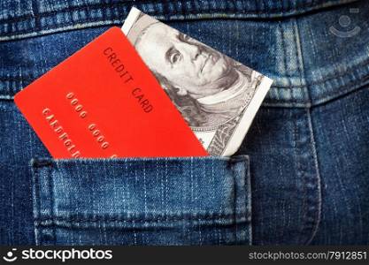 Close-up of Red Credit Card and One Hundred Dollar Note in the Pocket of the Jeans