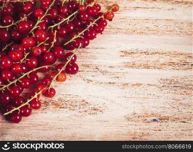Close-up of red currants on a wooden background.. Berries of ripe red currant on wooden background