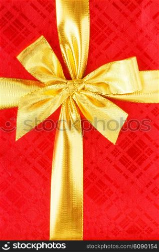 Close up of red gift box with gold bow