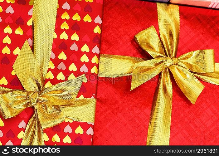 Close up of red gift box with golden ribbon