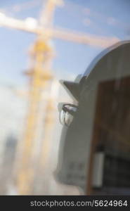 Close-up of reflection of architect on construction site