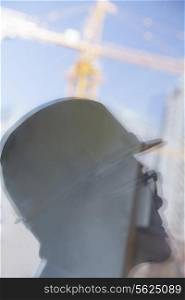 Close-up of reflection of architect on construction site