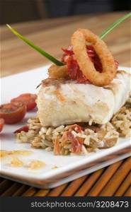 Close-up of rice and a fish fillet in a plate