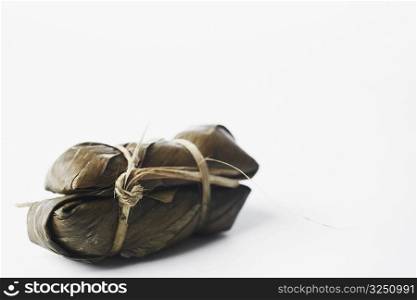 Close-up of rice wrapped in banana leaves