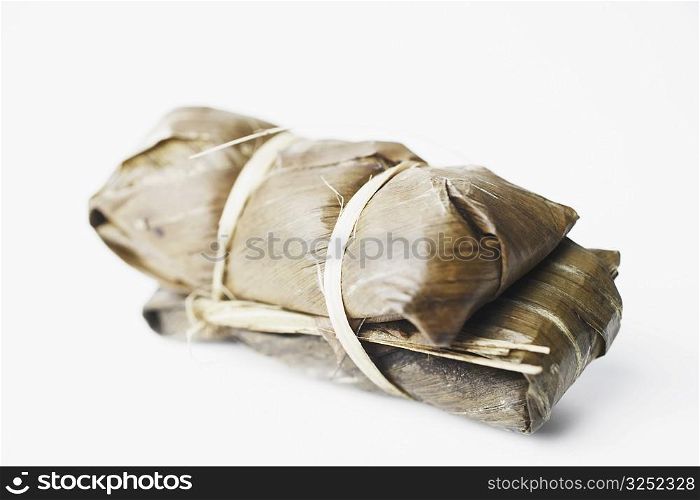 Close-up of rice wrapped in banana leaves