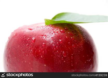 Close-up of ripe fresh red apple with leaf isolated on white