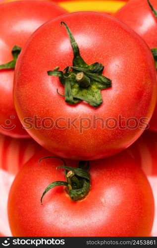 Close up of ripe red tomato, tomatoes background.