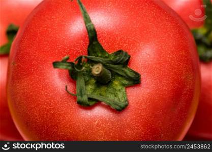 Close up of ripe red tomato, tomatoes background.